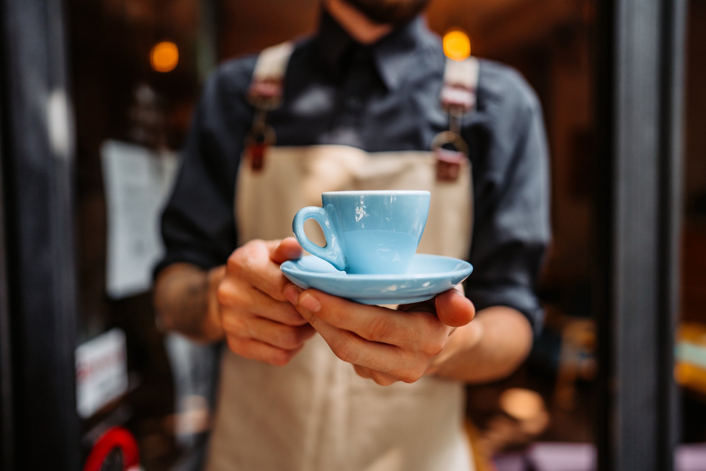 Barista serving coffee